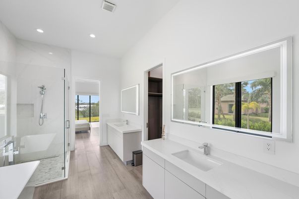Bathroom, Dual Sink Vanities, Glass Shower, Interior, Marble Walls, Recessed Lighting, Wood Texture Flooring
