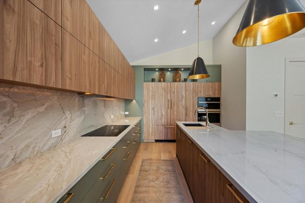 Interior, Kitchen, Marble Walls, Pendant Lights, Recessed Lighting, Stainless Steel Appliances, Wood Texture Flooring
