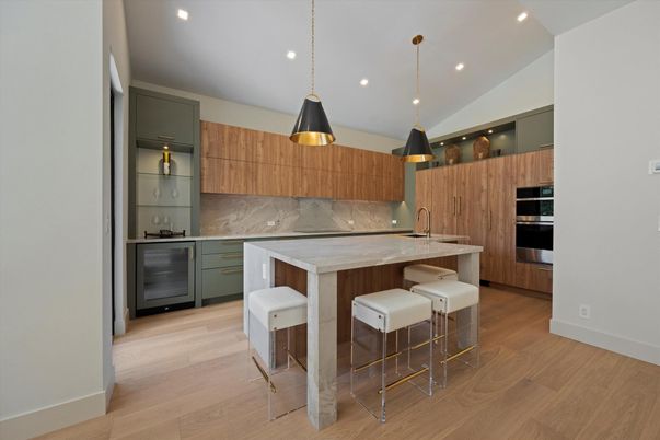 Interior, Kitchen, Marble Walls, Pendant Lights, Recessed Lighting, Stainless Steel Appliances, Wood Texture Flooring