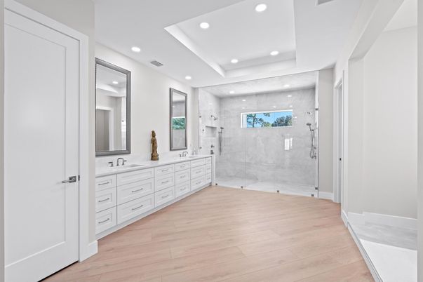 Bathroom, Dual Sink Vanities, Glass Shower, Interior, Marble Walls, Recessed Lighting, Wood Texture Flooring