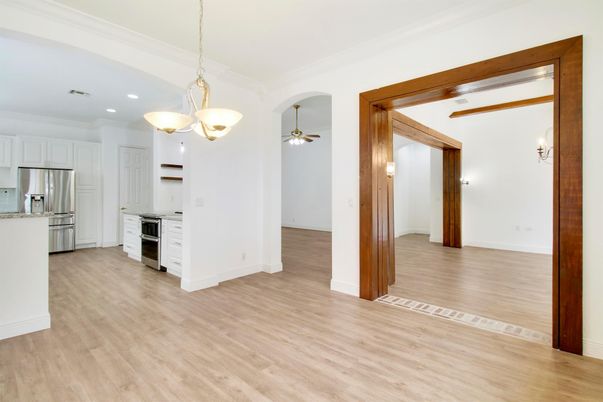 Empty room, Interior, Kitchen, Pendant Lights, Recessed Lighting, Stainless Steel Appliances, Wood Texture Flooring