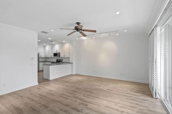 Empty room, Interior, Kitchen, Recessed Lighting, Stainless Steel Appliances, Wood Texture Flooring