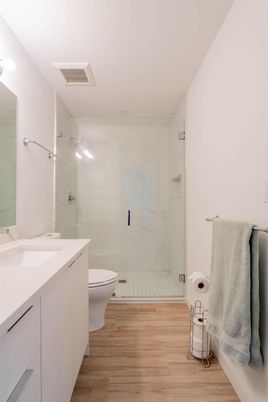 Bathroom, Glass Shower, Interior, Marble Walls, Wood Texture Flooring