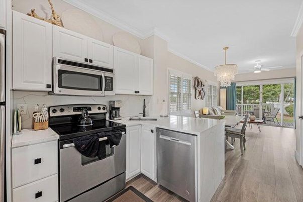 Chandelier, Dining room, Interior, Kitchen, Stainless Steel Appliances, Wood Texture Flooring