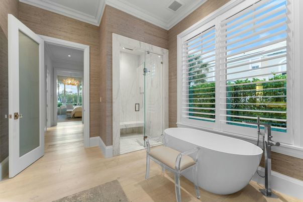 Bathroom, Free Standing Baths, Glass Shower, Interior, Marble Walls, Recessed Lighting, Wood Texture Flooring, Wooden Walls