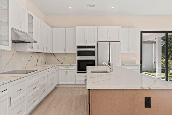 Interior, Kitchen, Marble Walls, Recessed Lighting, Stainless Steel Appliances, Wood Texture Flooring
