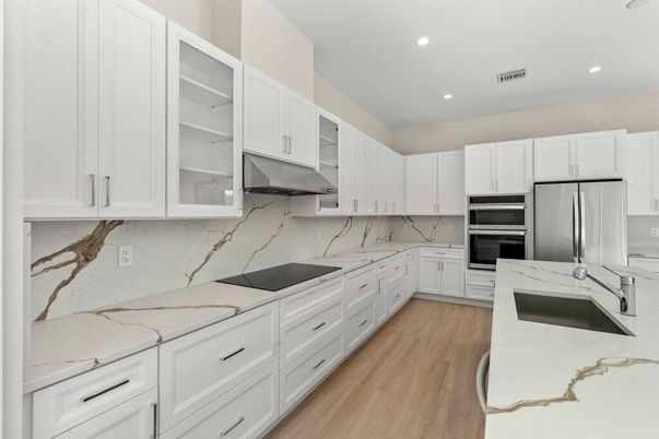 Interior, Kitchen, Marble Walls, Recessed Lighting, Stainless Steel Appliances, Wood Texture Flooring