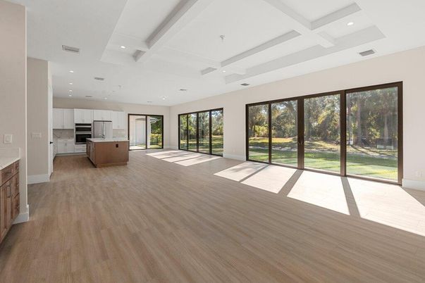 Empty room, Interior, Kitchen, Recessed Lighting, Stainless Steel Appliances, Wood Texture Flooring