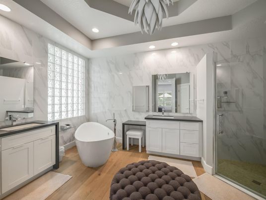 Bathroom, Dual Sink Vanities, Free Standing Baths, Glass Shower, Interior, Marble Walls, Recessed Lighting, Wood Texture Flooring