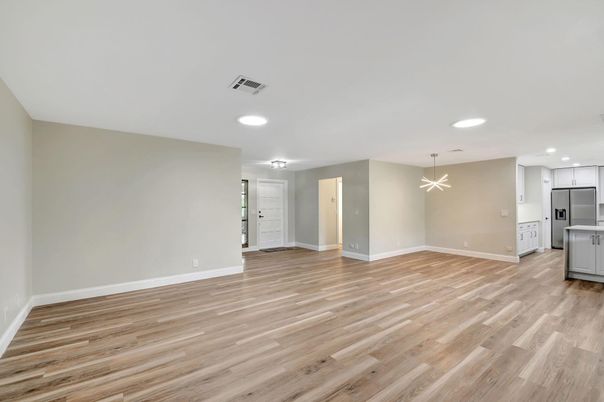 Empty room, Interior, Kitchen, Recessed Lighting, Stainless Steel Appliances, Wood Texture Flooring