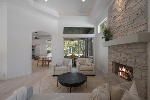 Dining room, Fireplace, Interior, Living room, Recessed Lighting, Stone Walls, Wood Texture Flooring