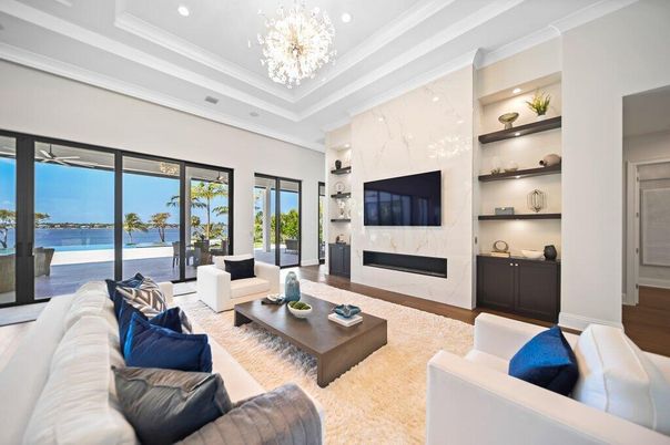 Chandelier, Fireplace, Interior, Living room, Marble Walls, Recessed Lighting, Water, Wood Texture Flooring