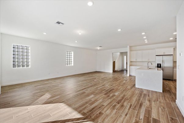 Empty room, Interior, Kitchen, Recessed Lighting, Stainless Steel Appliances, Wood Texture Flooring