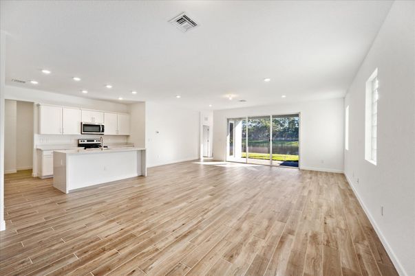 Empty room, Interior, Kitchen, Recessed Lighting, Stainless Steel Appliances, Wood Texture Flooring