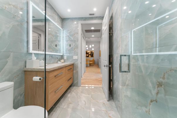 Bathroom, Glass Shower, Interior, Marble Walls, Recessed Lighting, Wood Texture Flooring