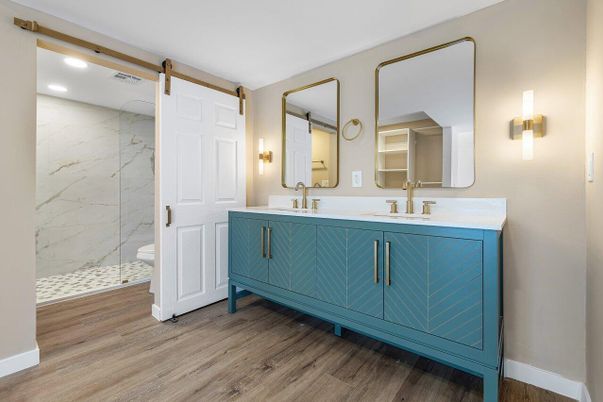 Bathroom, Dual Sink Vanities, Interior, Marble Walls, Recessed Lighting, Wood Texture Flooring