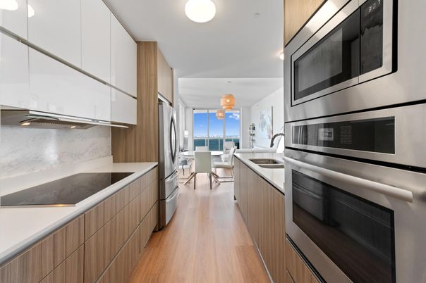 Dining room, Interior, Kitchen, Marble Walls, Pendant Lights, Stainless Steel Appliances, Water, Wood Texture Flooring