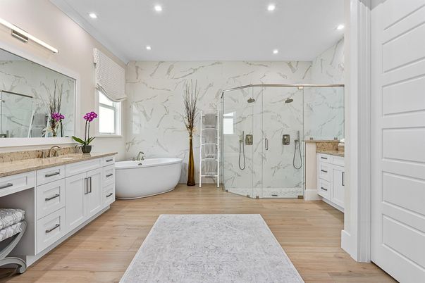 Bathroom, Dual Sink Vanities, Free Standing Baths, Glass Shower, Interior, Marble Walls, Recessed Lighting, Wood Texture Flooring