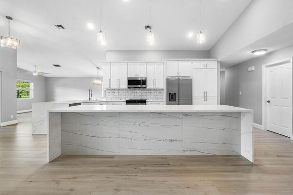 Interior, Kitchen, Marble Walls, Pendant Lights, Recessed Lighting, Stainless Steel Appliances, Wood Texture Flooring