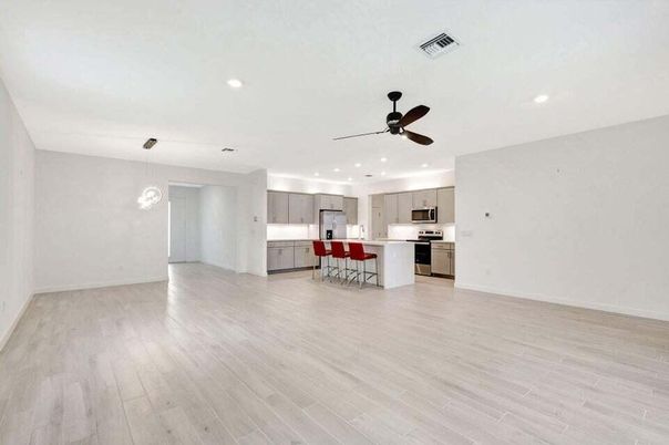 Dining room, Empty room, Interior, Kitchen, Pendant Lights, Recessed Lighting, Stainless Steel Appliances, Wood Texture Flooring