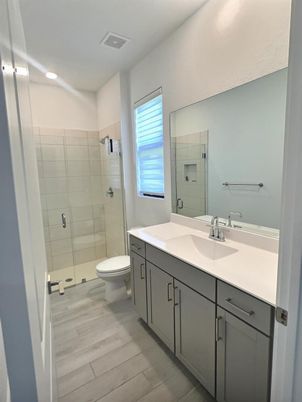 Bathroom, Dual Sink Vanities, Glass Shower, Interior, Recessed Lighting, Wood Texture Flooring