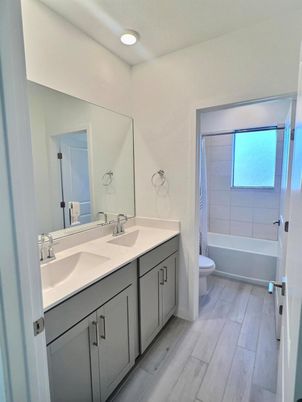 Bathroom, Dual Sink Vanities, Interior, Recessed Lighting, Wood Texture Flooring