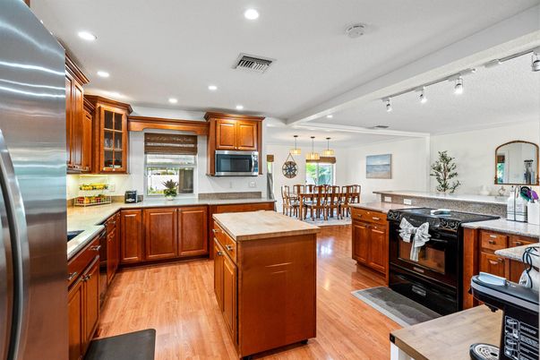 Dining room, Interior, Kitchen, Pendant Lights, Recessed Lighting, Stainless Steel Appliances, Wood Texture Flooring