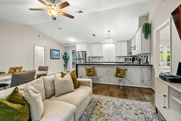 Chandelier, Interior, Kitchen, Living room, Marble Walls, Pendant Lights, Recessed Lighting, Stainless Steel Appliances, Wood Texture Flooring