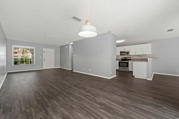 Empty room, Interior, Kitchen, Pendant Lights, Stainless Steel Appliances, Wood Texture Flooring