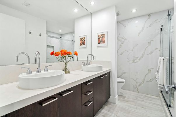 Bathroom, Dual Sink Vanities, Glass Shower, Interior, Marble Walls, Recessed Lighting, Wood Texture Flooring