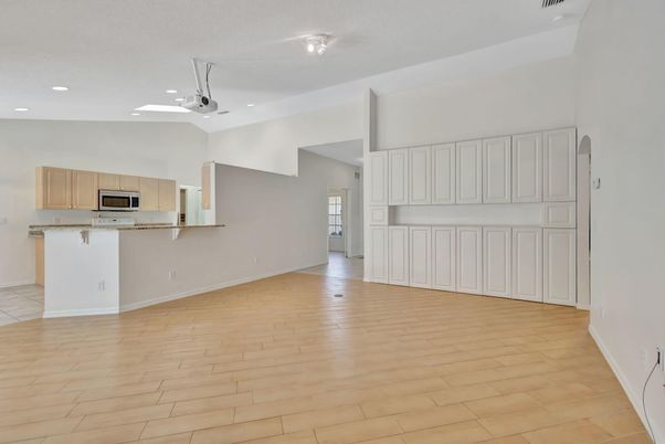 Empty room, Interior, Kitchen, Recessed Lighting, Stainless Steel Appliances, Wood Texture Flooring