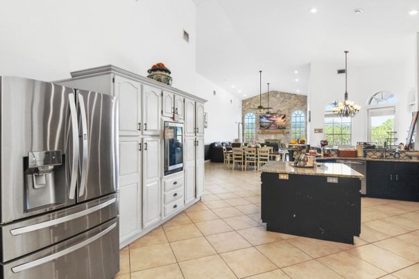 Chandelier, Dining room, Fireplace, Interior, Kitchen, Living room, Pendant Lights, Recessed Lighting, Stainless Steel Appliances, Stone Walls