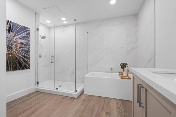 Bathroom, Free Standing Baths, Glass Shower, Interior, Marble Walls, Recessed Lighting, Wood Texture Flooring