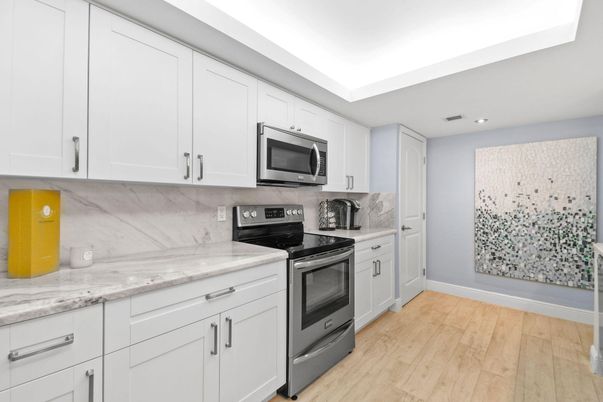 Interior, Kitchen, Marble Walls, Recessed Lighting, Stainless Steel Appliances, Wood Texture Flooring