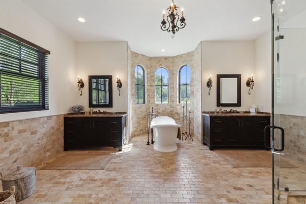Bathroom, Chandelier, Dual Sink Vanities, Free Standing Baths, Glass Shower, Interior, Recessed Lighting, Stone Walls