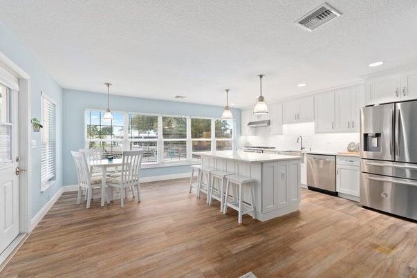 Dining room, Interior, Kitchen, Pendant Lights, Recessed Lighting, Stainless Steel Appliances, Wood Texture Flooring