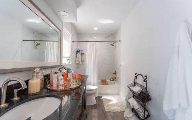 Bathroom, Dual Sink Vanities, Interior, Marble Walls, Recessed Lighting, Wood Texture Flooring