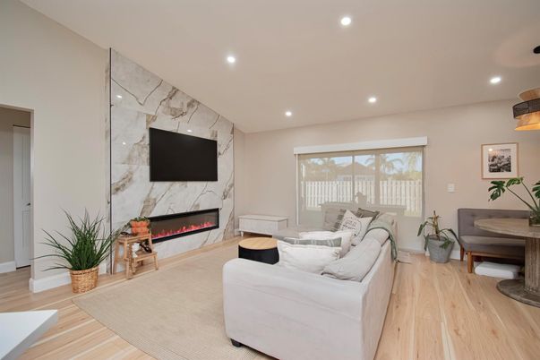Fireplace, Interior, Living room, Marble Walls, Recessed Lighting, Wood Texture Flooring