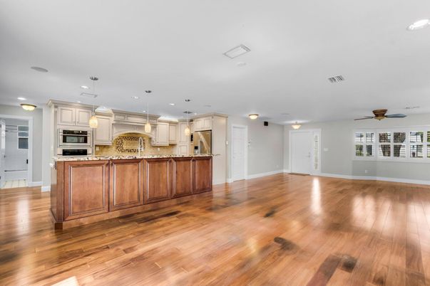 Empty room, Interior, Kitchen, Pendant Lights, Recessed Lighting, Stainless Steel Appliances, Wood Texture Flooring