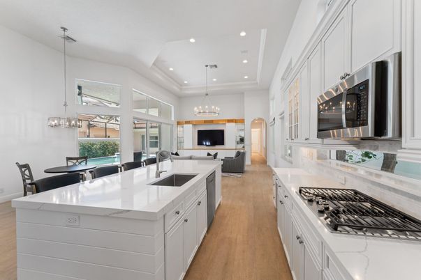 Chandelier, Interior, Kitchen, Living room, Pendant Lights, Recessed Lighting, Stainless Steel Appliances, Wood Texture Flooring