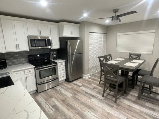 Dining room, Interior, Kitchen, Recessed Lighting, Stainless Steel Appliances, Wood Texture Flooring