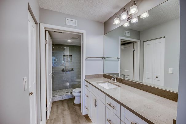 Bathroom, Dual Sink Vanities, Glass Shower, Interior, Recessed Lighting, Wood Texture Flooring