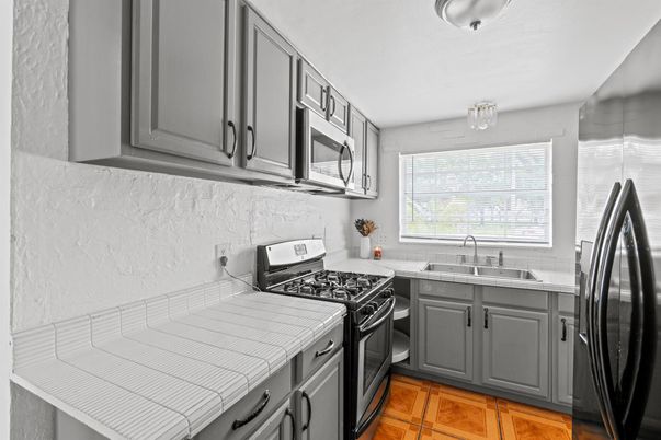 Interior, Kitchen, Stainless Steel Appliances, Tile Countertops, Wood Texture Flooring