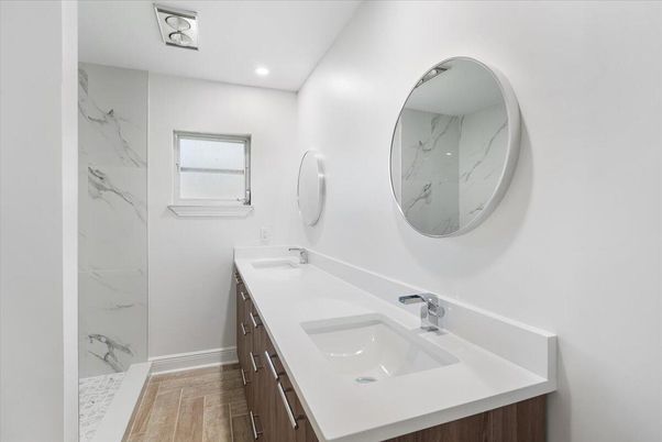 Bathroom, Dual Sink Vanities, Interior, Marble Walls, Recessed Lighting, Wood Texture Flooring
