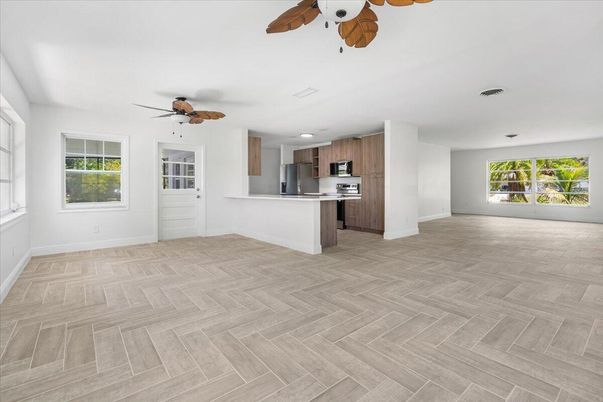 Empty room, Interior, Kitchen, Recessed Lighting, Stainless Steel Appliances, Wood Texture Flooring