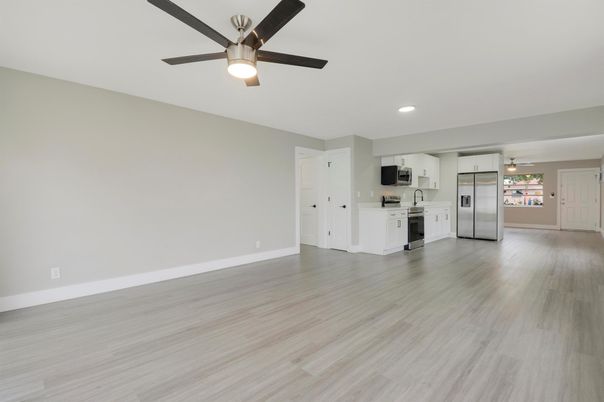 Empty room, Interior, Kitchen, Recessed Lighting, Stainless Steel Appliances, Wood Texture Flooring