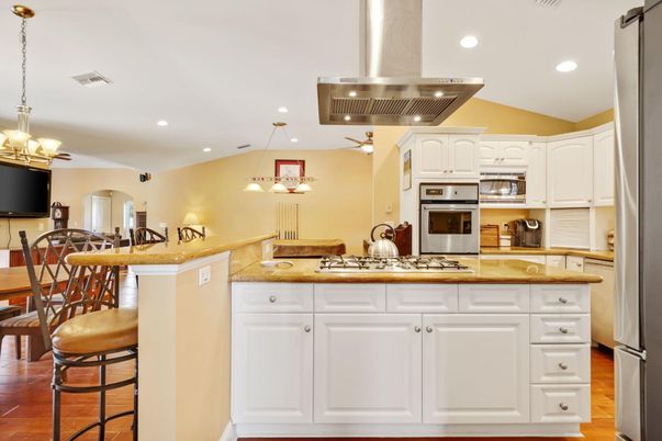 Chandelier, Dining room, Interior, Kitchen, Pendant Lights, Recessed Lighting, Stainless Steel Appliances, Wood Texture Flooring