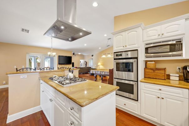 Chandelier, Dining room, Interior, Kitchen, Living room, Pendant Lights, Recessed Lighting, Stainless Steel Appliances, Wood Texture Flooring