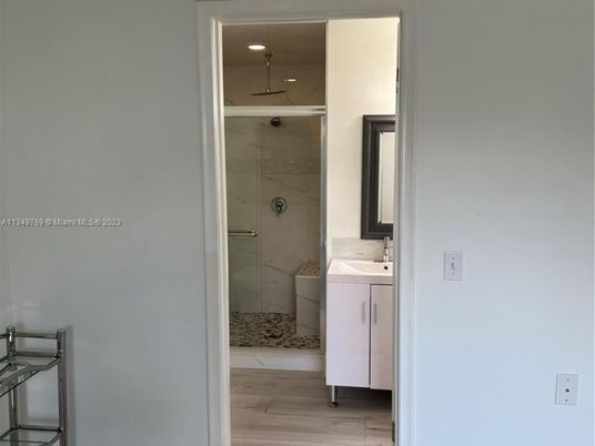 Bathroom, Glass Shower, Interior, Marble Walls, Wood Texture Flooring