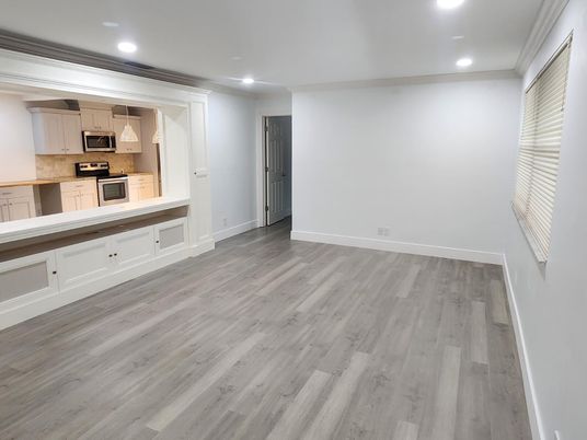 Empty room, Interior, Kitchen, Pendant Lights, Recessed Lighting, Stainless Steel Appliances, Wood Texture Flooring